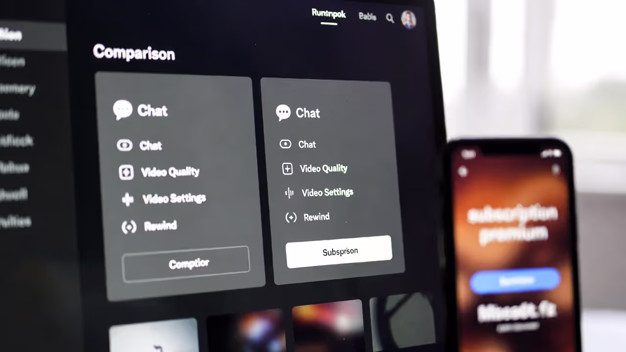 Streaming platform comparison on a laptop with blurred features and subscription screen on a phone