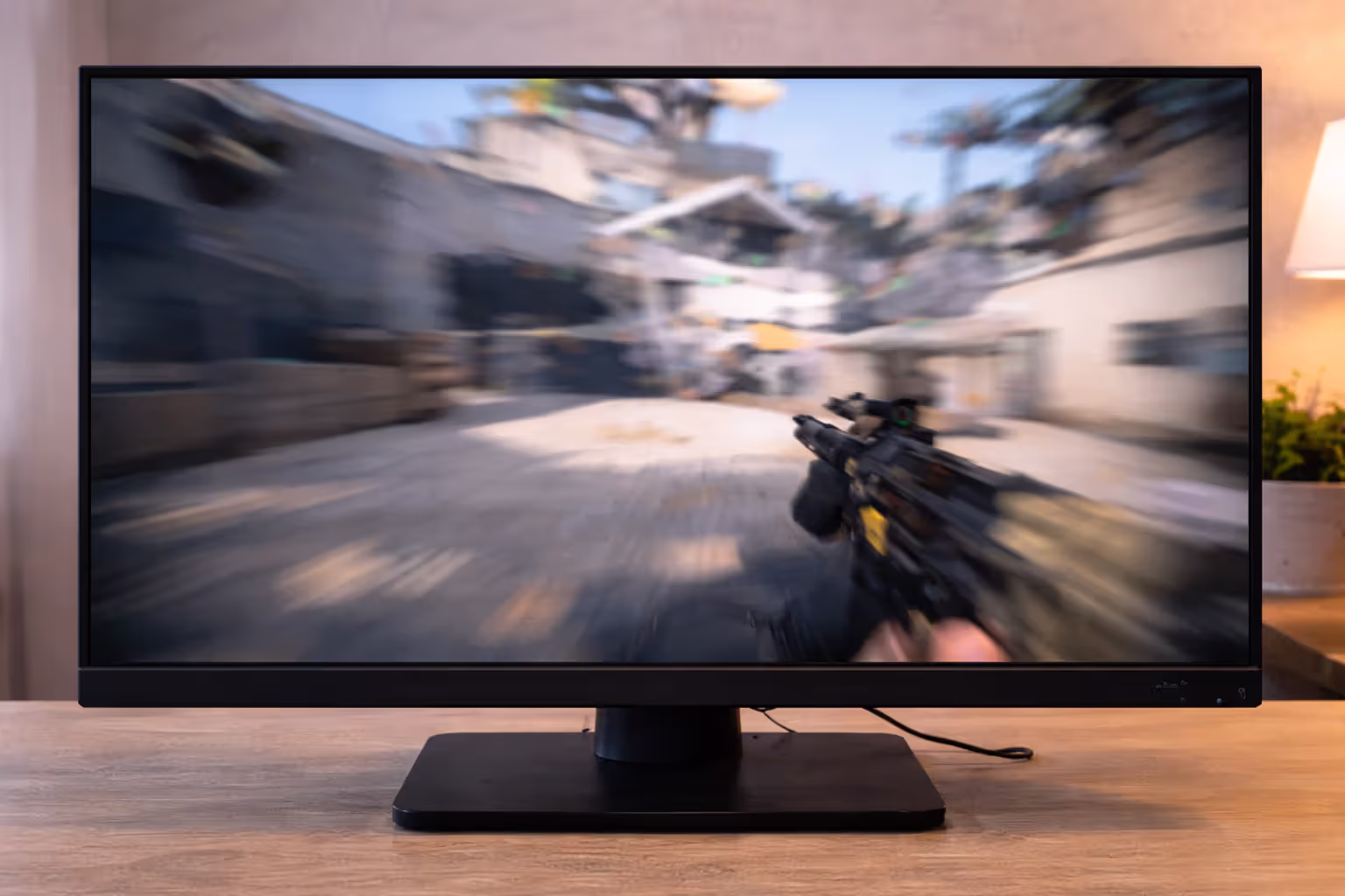 Close-up of a gaming monitor showing motion blur and ghosting in a fast scene