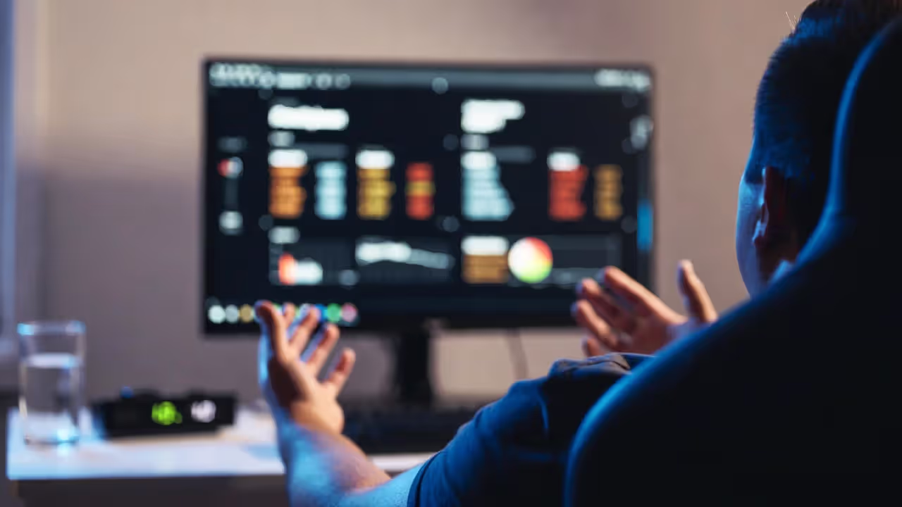 Player stepping away from the desk after a loss with a blurred defeat screen