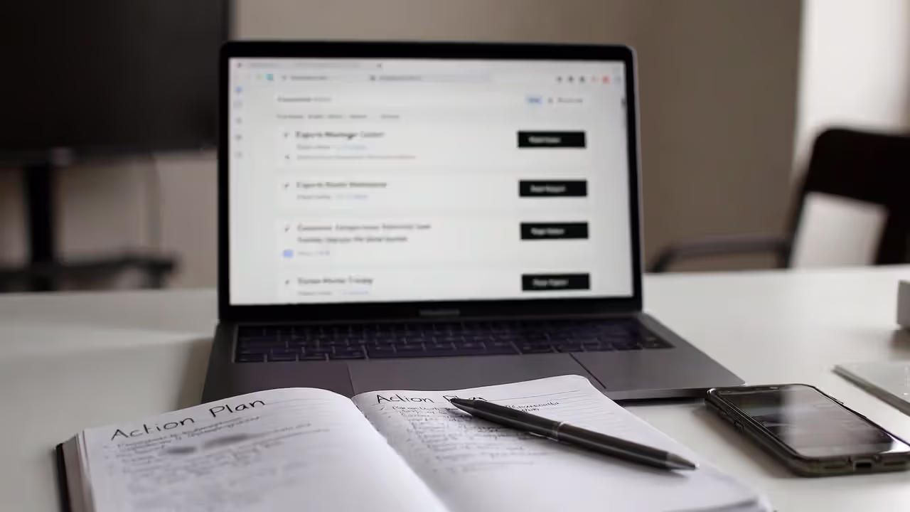 Planning an esports job search with laptop, notes, and blurred job listings on screen